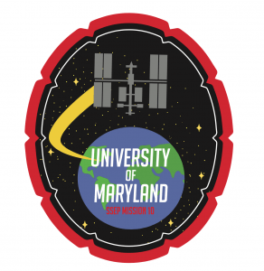 UMD Terps in Space patch showing the international space station orbiting around Earth, bot surrounded by a UMD shell border